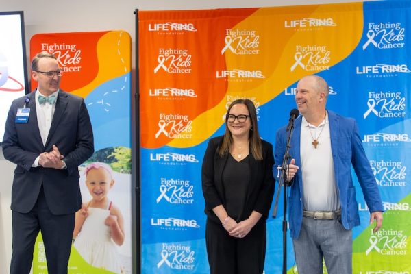 Carilion Clinic's Dr. Andrew Herman, department chair of pediatrics, and Kelly Woolwine, Life Ring Foundation Co-Founder, make remarks during the Life Ring Foundation check presentation and announcement at Carilion Children's Tanglewood on Tuesday, Dec. 2, 2025, in Roanoke, Virginia.